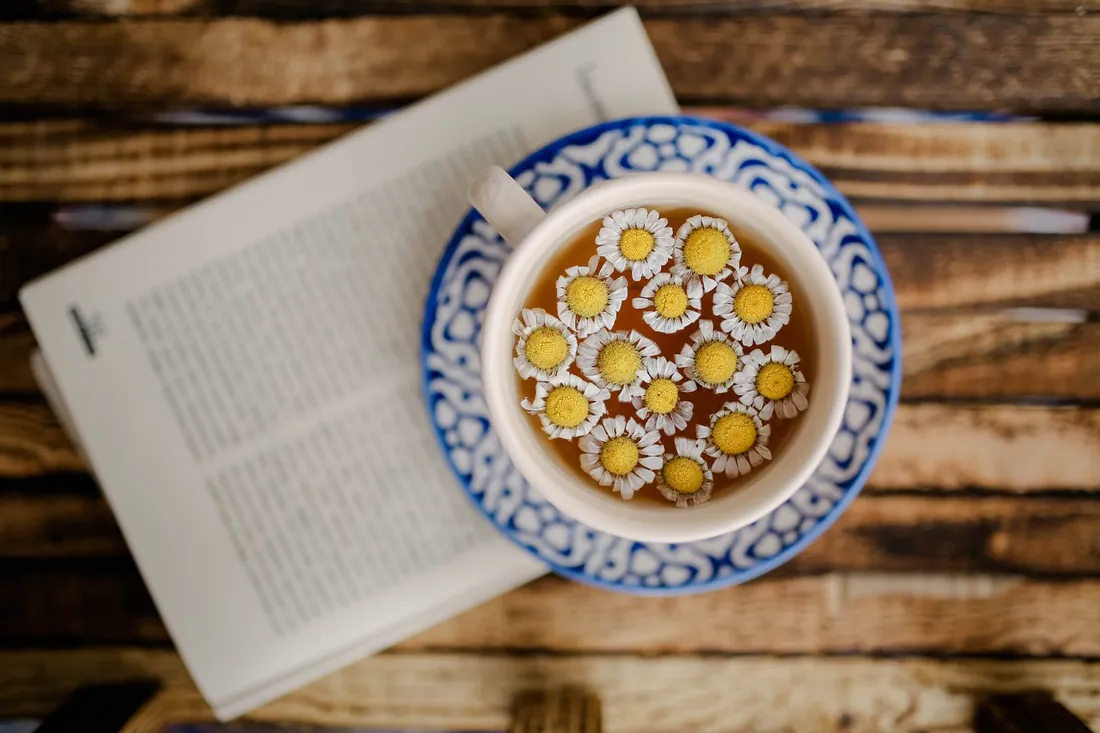 Caffeine-free chamomile tea and a book for a natural evening wind-down