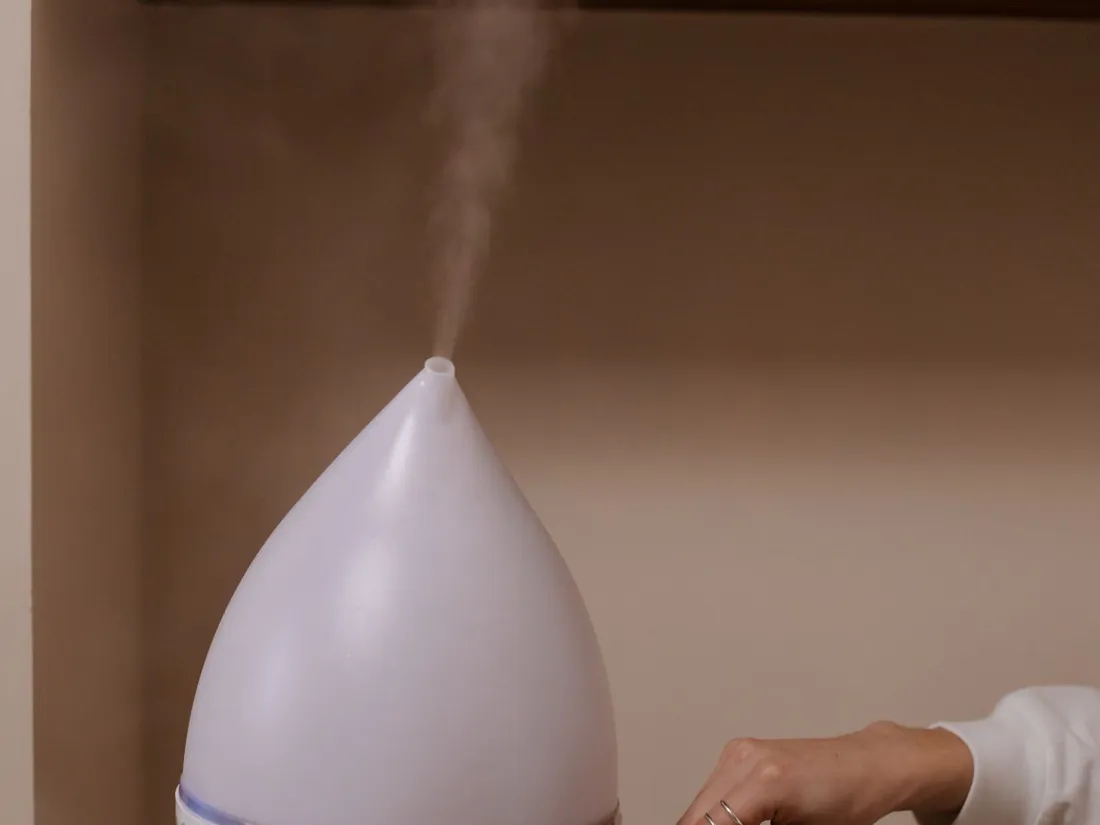 Humidifier on a wooden stool, a natural way to sleep better in dry winter air